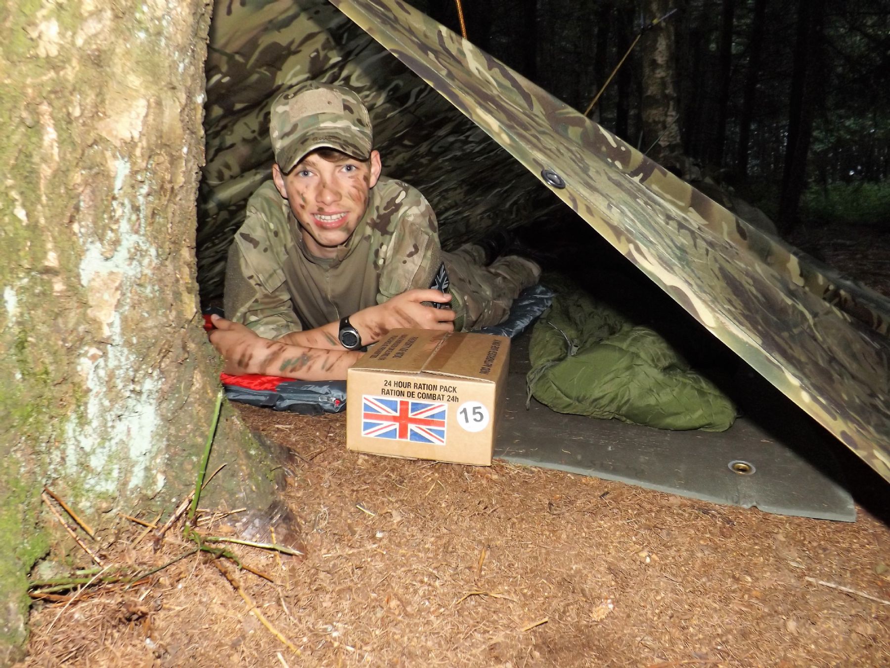  A CCF student smiling under a bivy