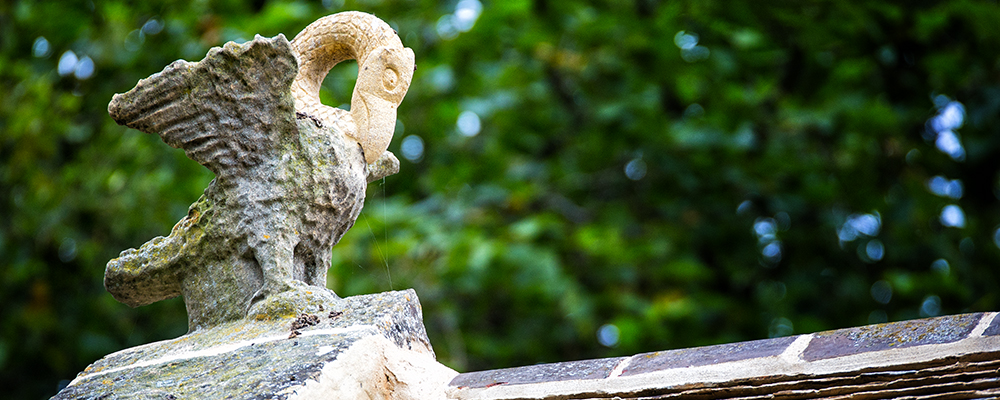 The Pias Pelican carving on the Old School Roof