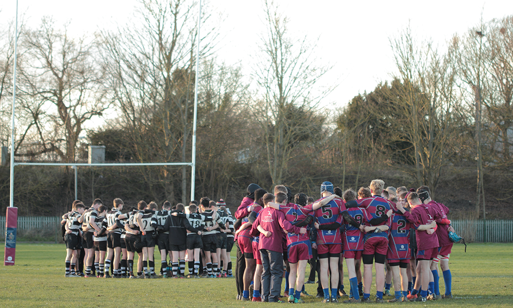  Students talking at half time in a rugby match